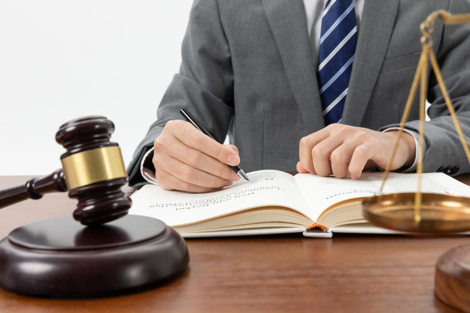 closeup-shot-person-writing-book-with-gavel-table-1-scaled.jpg closeup-shot-person-writing-book-with-gavel-table-1-scaled.jpg